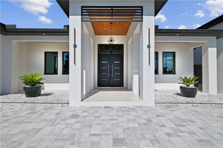 Entrance to property featuring stucco siding
