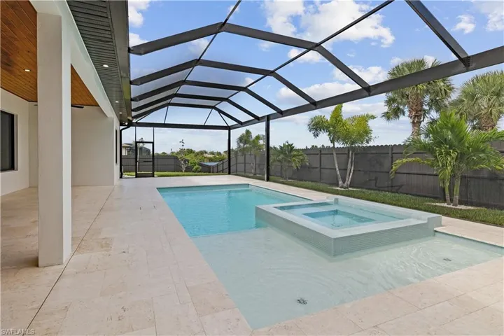 View of pool featuring a patio area, a sunroom, glass enclosure, and a fenced backyard