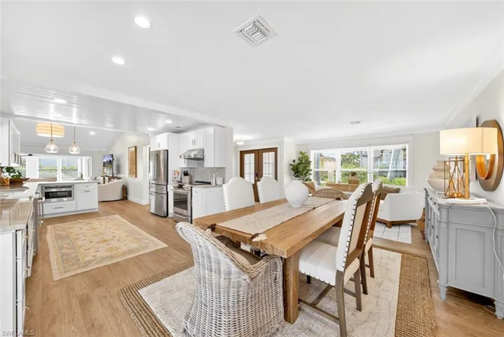 Spacious dining area featuring wood-finish flooring and recessed lighting