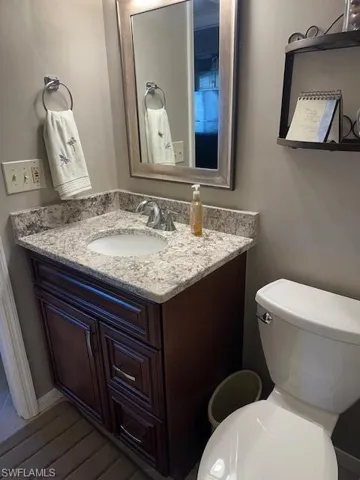 Half bath featuring vanity and toilet