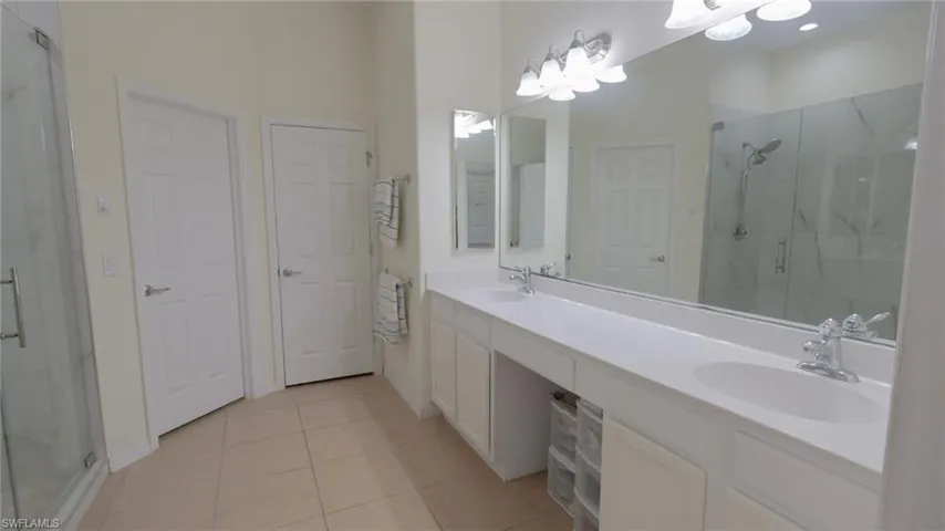 Master Bathroom with a shower stall, tile patterned flooring, and a sink