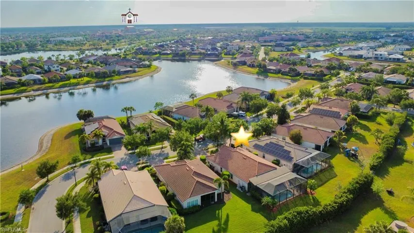 Drone / aerial view with a residential view and a water view