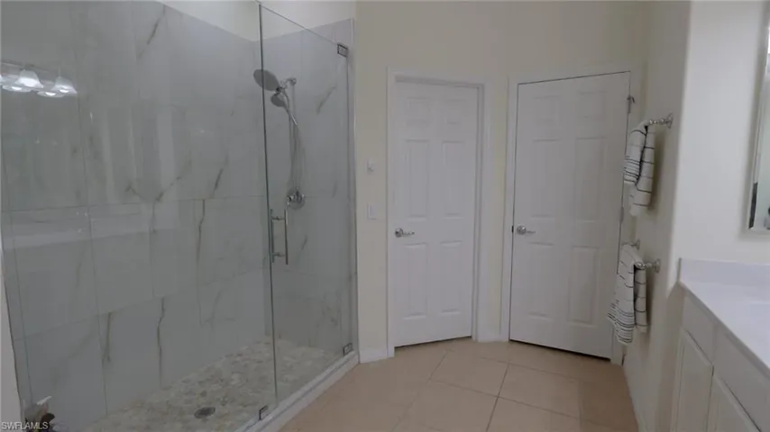 Master Bathroom featuring vanity, tile patterned floors, and a shower stall