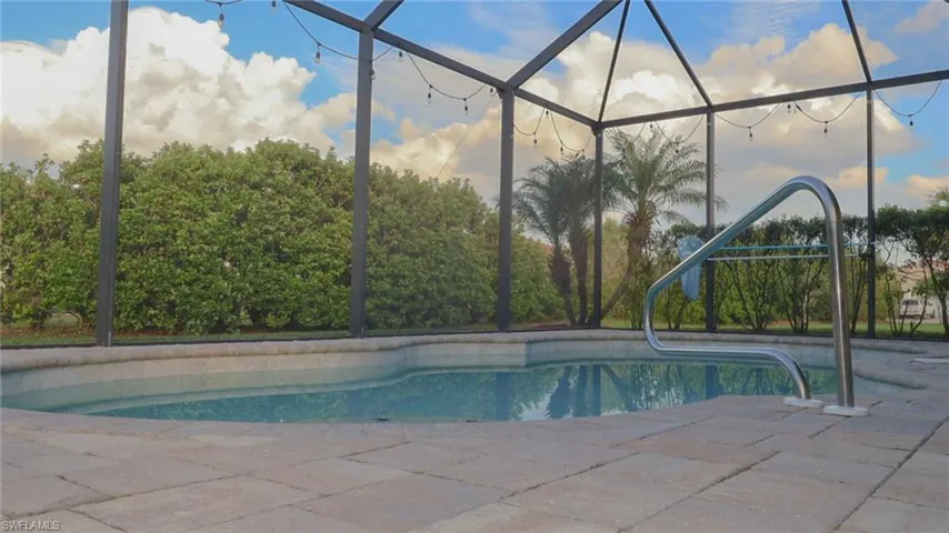 Pool with a lanai and a patio area