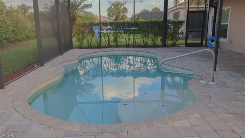 View of swimming pool with a fenced in pool, a lanai, and a patio area