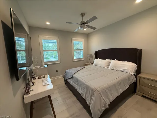 Bedroom with recessed lighting, light tile patterned flooring, and a ceiling fan