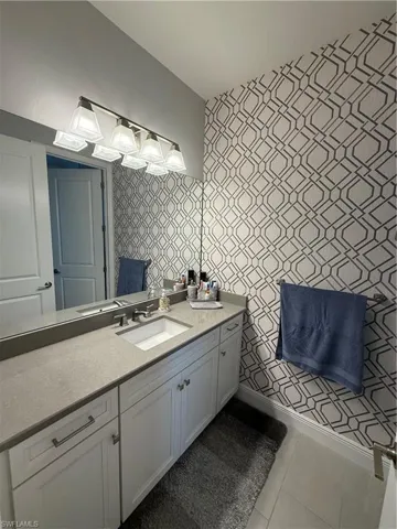 Bathroom with tile patterned floors and vanity