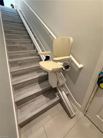 Stairway featuring baseboards and tile patterned floors
