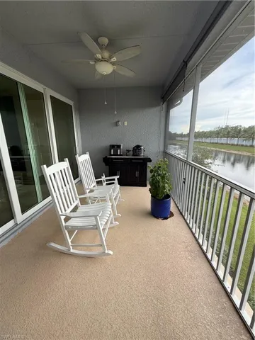 Balcony with a ceiling fan and a water view