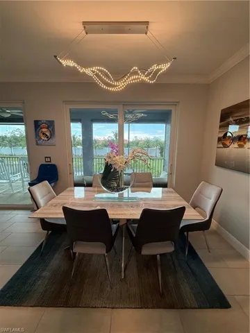 Tiled dining space with crown molding