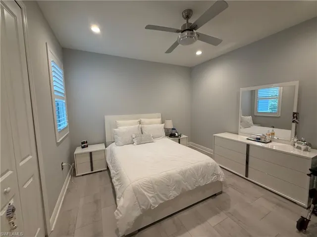 Bedroom with multiple windows, recessed lighting, ceiling fan, and wood tiled floors