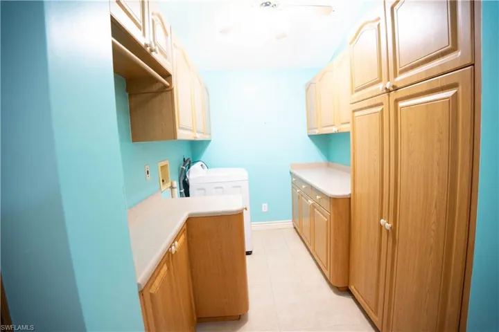 Laundry Room with Plenty of Cabinets.