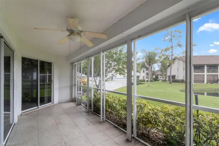 Unfurnished sunroom featuring ceiling fan and a wealth of natural light