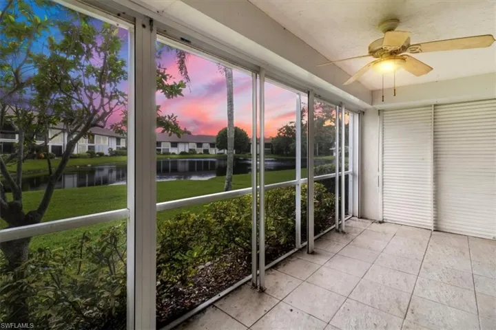 Unfurnished sunroom with a water view and ceiling fan