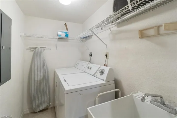 Laundry area featuring washing machine and dryer and sink