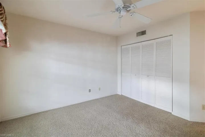 Unfurnished bedroom with a closet, ceiling fan, and carpet flooring