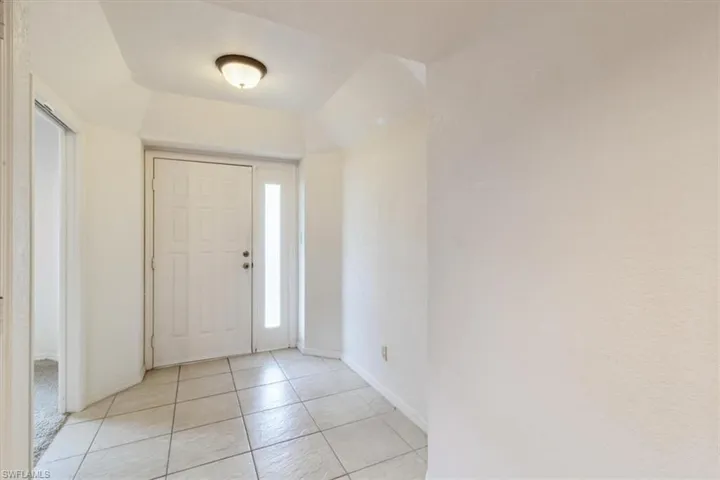 Entrance foyer with light tile patterned floors
