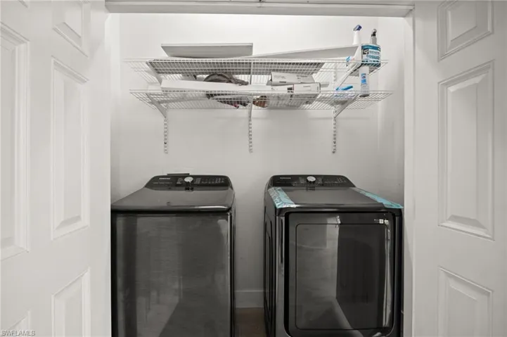 Washroom featuring independent washer and dryer