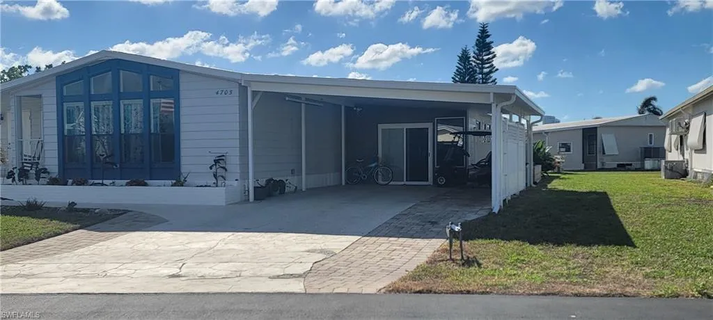 View of home's exterior showing the extra large carport