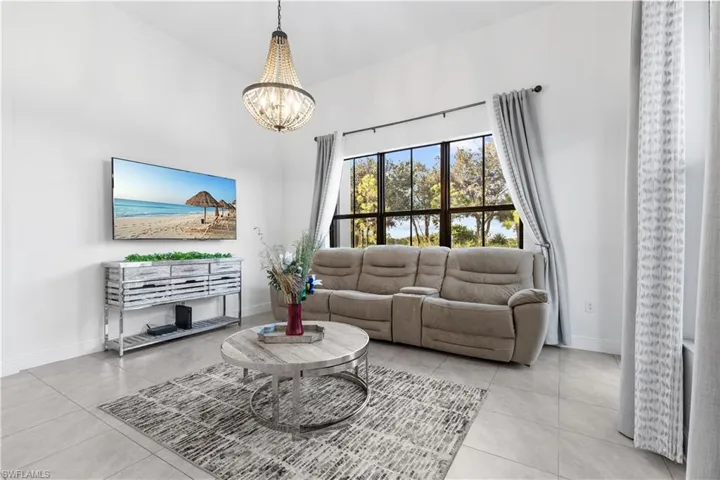 Tiled living room featuring a chandelier