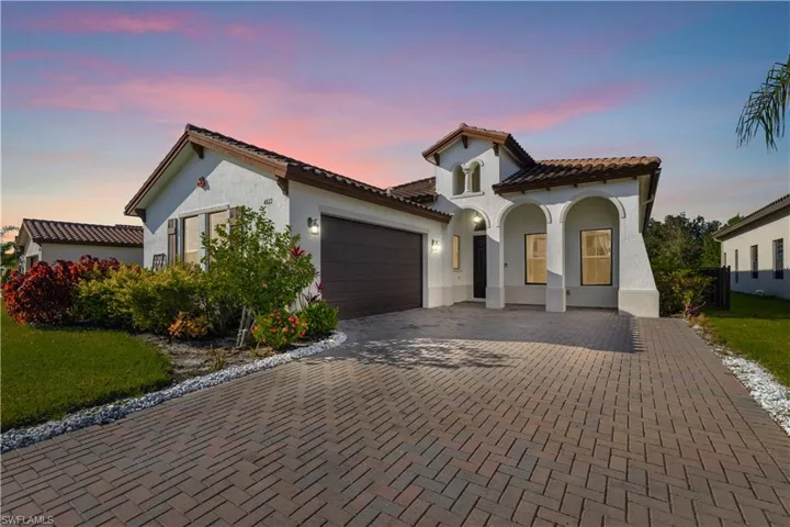 Mediterranean / spanish-style house with a garage