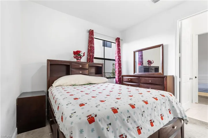 Bedroom featuring light carpet