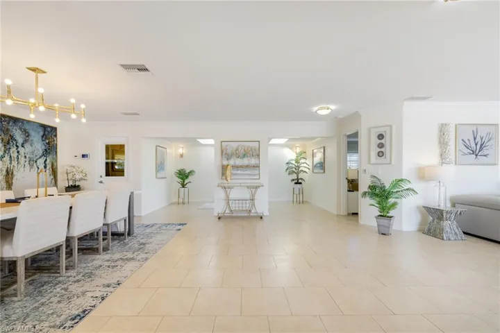 Dining area featuring crown molding and light tile patterned flooring