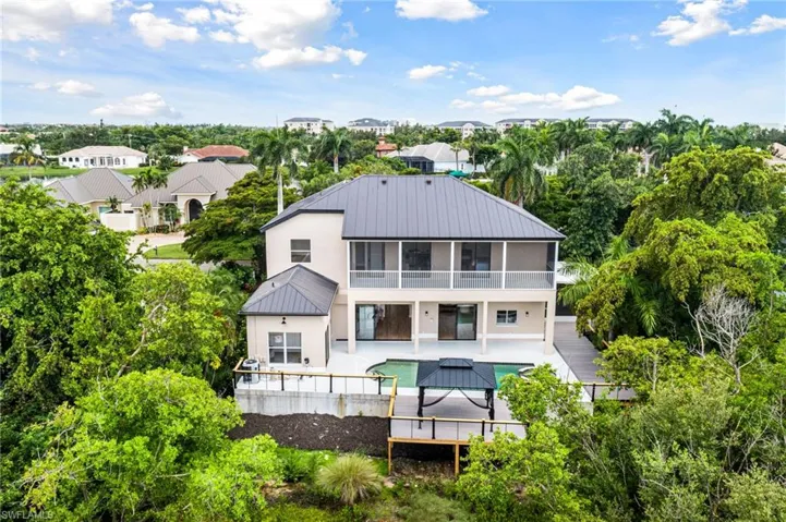 Back of property with private tropical surroundings
