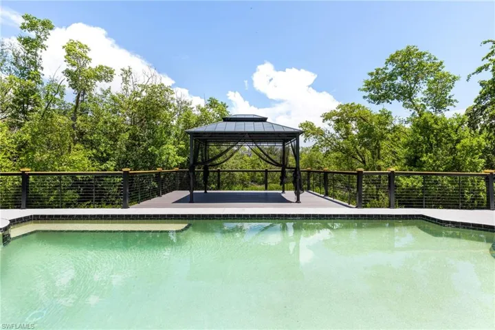 View of swimming pool with a gazebo