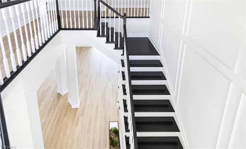 Stairway featuring hardwood / wood-style flooring