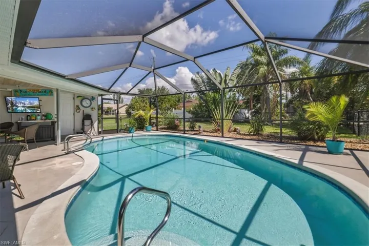Swimming pool with a patio area and a lanai