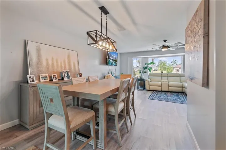 Dining space with light wood-style floors, baseboards, and ceiling fan
