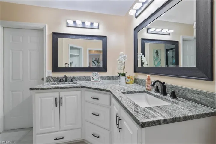 Full bath featuring double vanity and tile patterned floors