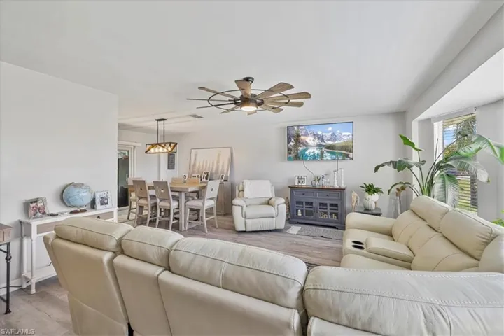 Living room featuring light wood-type flooring and a ceiling fan