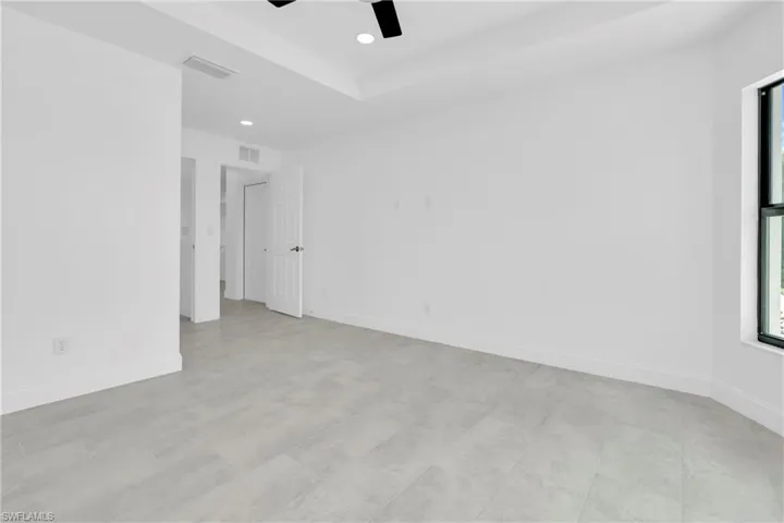 Unfurnished room with a ceiling fan, recessed lighting, and a raised ceiling