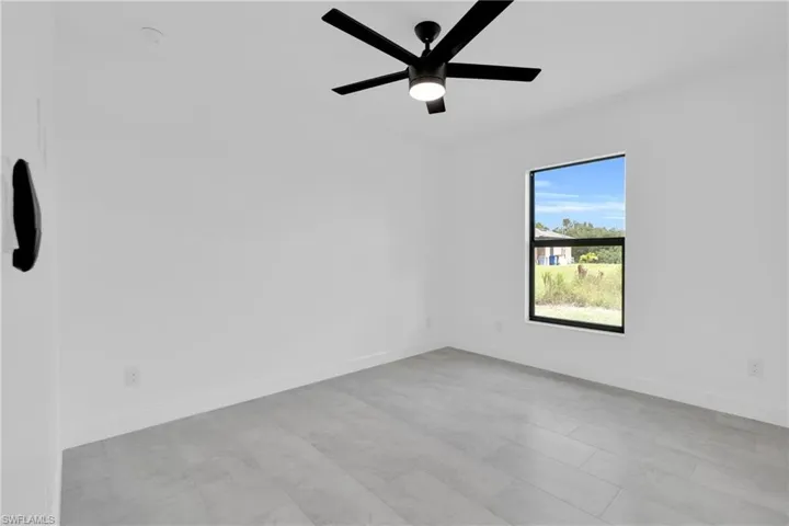 Spare room with baseboards and ceiling fan