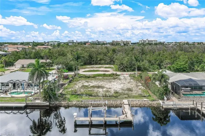 Birds eye view of property with a water view