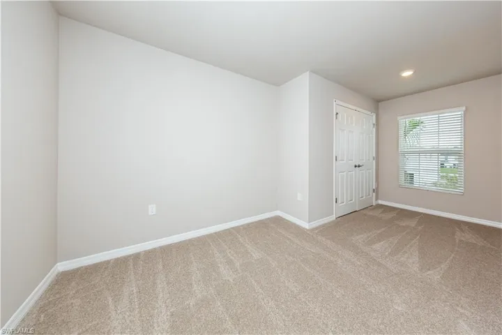 Unfurnished room featuring carpet floors, baseboards, and recessed lighting