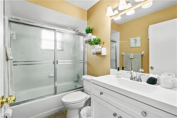 Bathroom with vanity and shower / bath combination with glass door