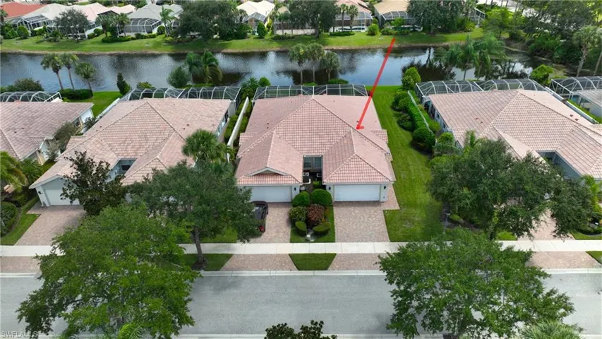Property with a barrel tile roof, paver driveway, and an attached two-car garage