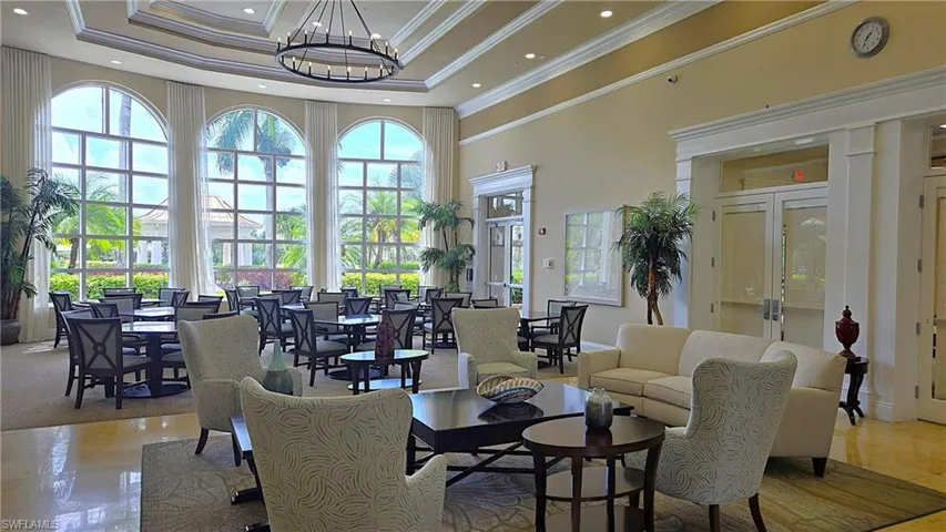Expansive main room featuring large arched windows, a coffered ceiling, and a prominent chandelier