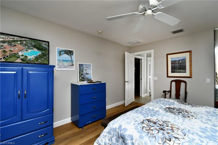 Wood-finish flooring, neutral wall color, and recessed lighting
