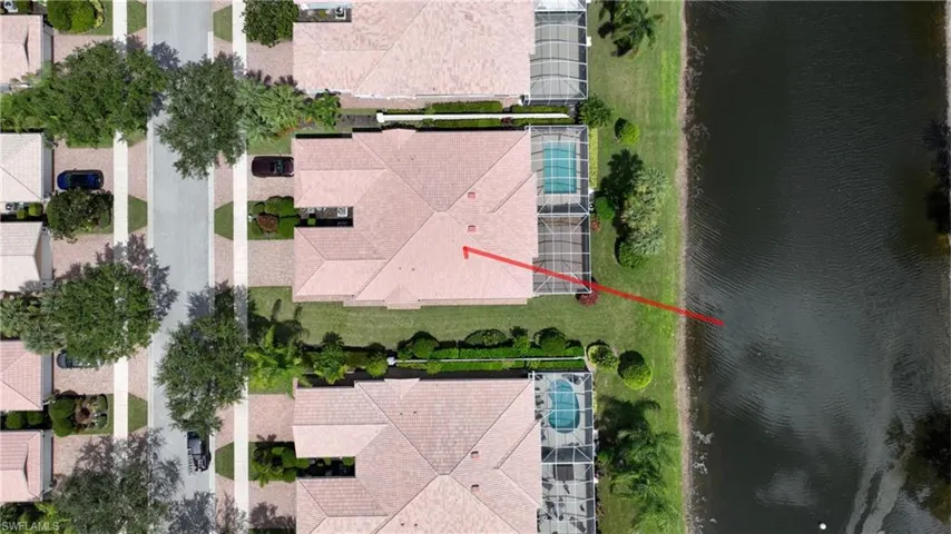 Property with tile roof and screened-in pool enclosure