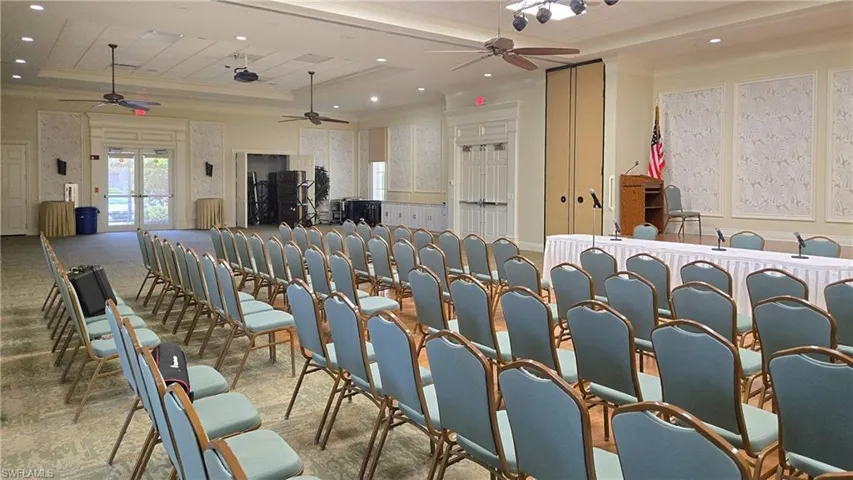Spacious event hall featuring ceiling fans, recessed lighting, and decorative wall panels