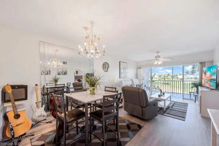 Dining area featuring hardwood / wood-style flooring and ceiling fan with notable chandelier