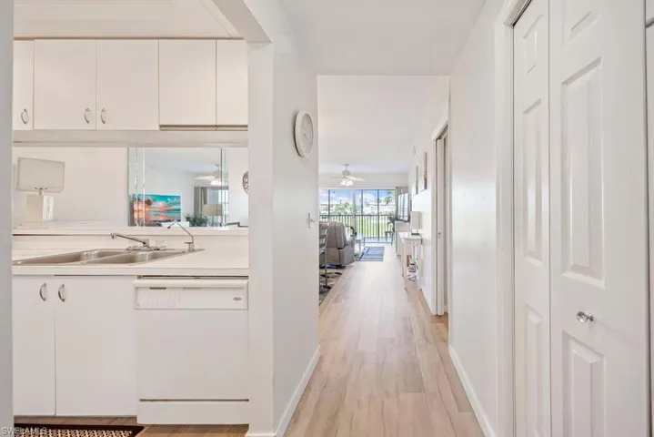 Hall with light hardwood / wood-style flooring and sink