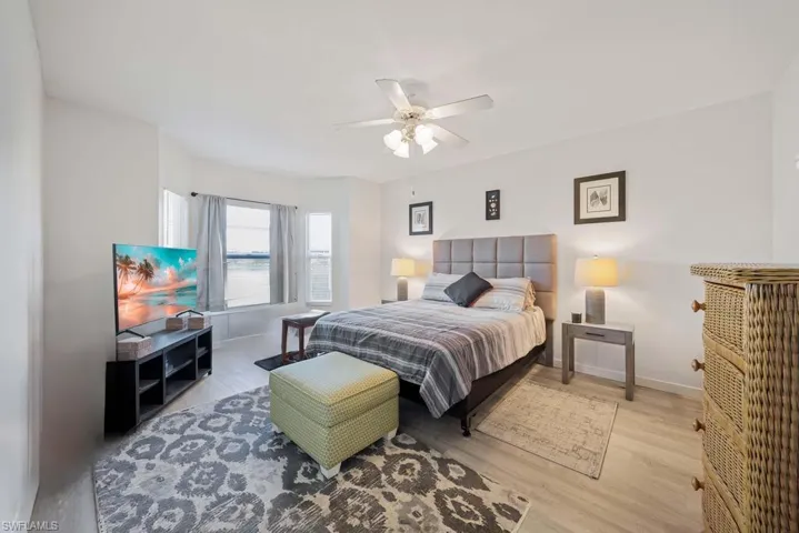 Bedroom with light hardwood / wood-style flooring and ceiling fan