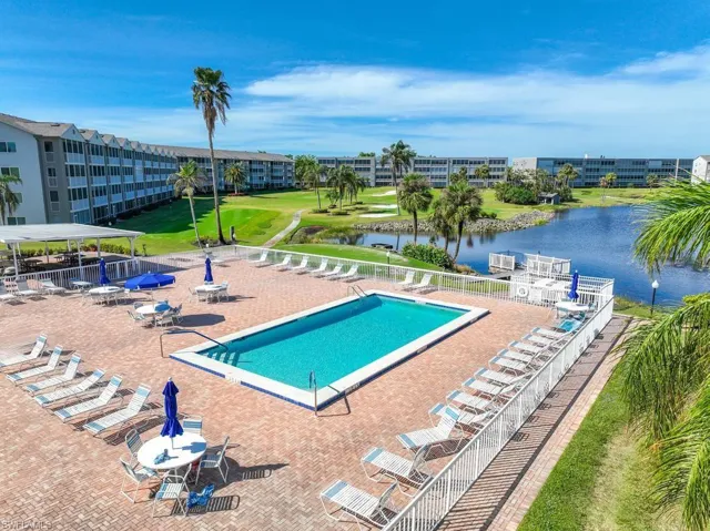 View of pool with a water view and a patio area