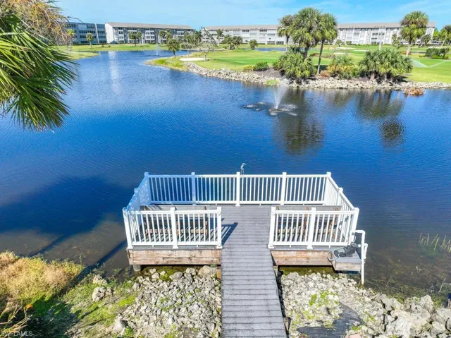 Dock area featuring a deck with water view