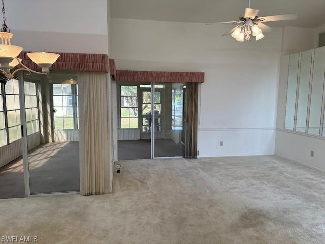 Living and dining open to one another with access to the enclosed lanai.